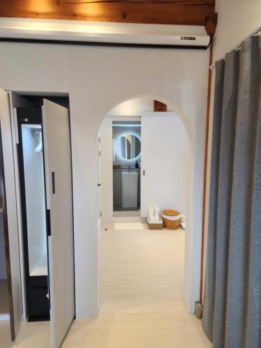 a hallway with white walls and an archway at Gyeong-ju Stayangim in Gyeongju