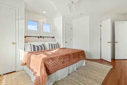 a bedroom with a bed and a window at 2 Min Walk to Beach -Ocean View-Heated Pool-Modern in Poplar Branch