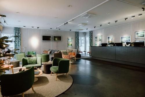 a large room with a lobby with green chairs at IceHotel in Jukkasjärvi