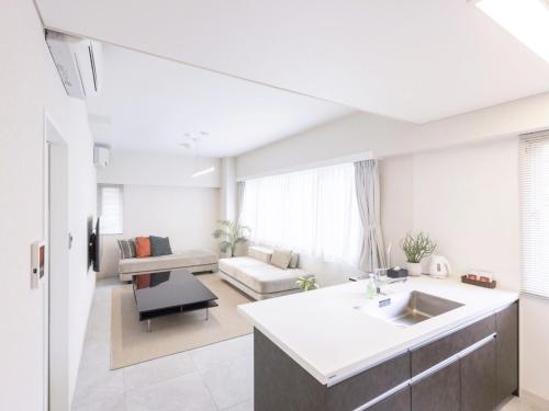 a kitchen and living room with a sink and a couch at MARSOL CS Beach hotel in Chigasaki