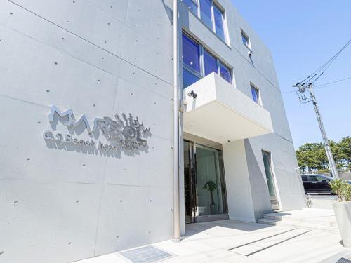 a building with a sign on the side of it at MARSOL CS Beach hotel in Chigasaki