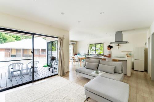 a living room with a couch and a table at Machicanty -まちかんてぃ- in Motobu