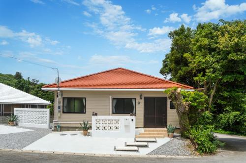 a house with an orange roof at Machicanty -まちかんてぃ- in Motobu