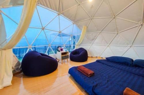 a room with a bed and two chairs in a igloo at ม่อน ซากุระ ม่อนแจ่ม in Mon Jam
