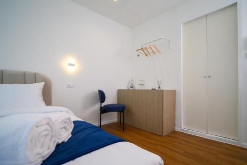 a bedroom with a bed and a dresser in it at Yummy House in Bangkok