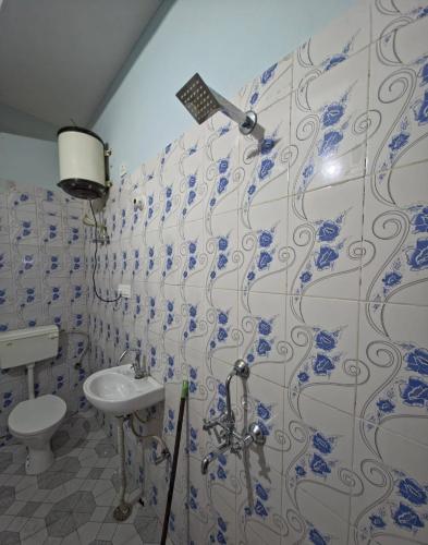 a bathroom with a toilet and a sink at Grandma s Nest in Bhīm Tāl