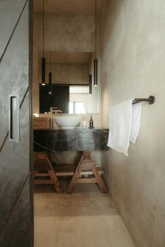 a bathroom with a sink and a counter with a mirror at The Iggy Hotel Seseh Studio 1 Sauna, Ice Bath in Cemagi