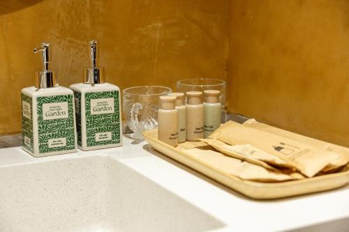 a counter with two bottles of soap and a sink at Amazing Ninh Binh Garden in Xuân Sơn