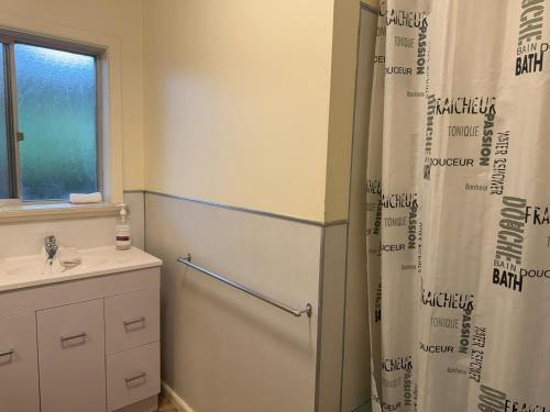 a bathroom with a refrigerator and a sink at Ovensview On Riverside in Bright