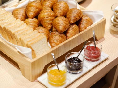 a tray of bread and pastries on a table at JR Kyushu Hotel Nagasaki in Nagasaki
