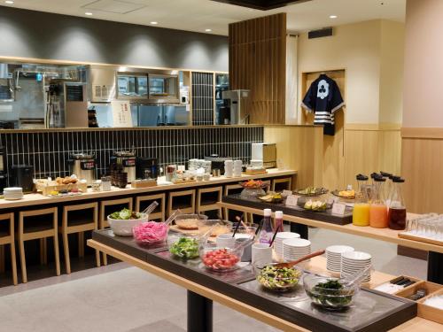a restaurant with a buffet of food on a table at JR Kyushu Hotel Nagasaki in Nagasaki