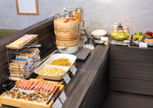 a buffet line with many different food items on it at APA Hotel Kanda Jimbocho Ekihigashi in Tokyo