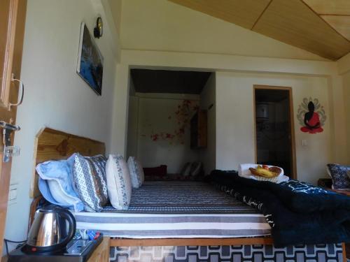 a bed with pillows on it in a room at The Sigiriya Old manali in Manāli