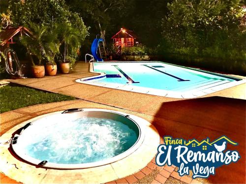 a large swimming pool in a backyard with a swimming pool at Finca El Remanso La Vega in La Vega