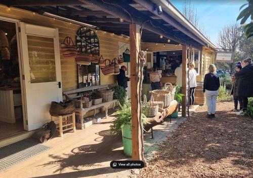 a group of people standing outside of a store at Serenity in Red Hill - Winery Bliss & Coastal Beauty in Red Hill South