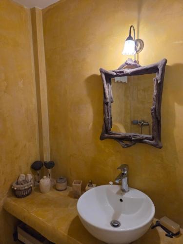 a bathroom with a sink and a mirror at Phaedra Villa Kythnos in Kithnos