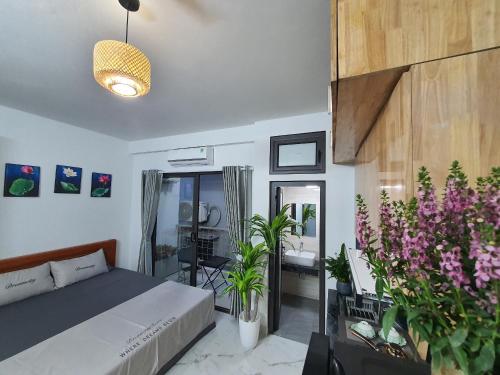 a bedroom with a bed and some plants at The Chilling'N Homestay Ha Noi 89 in Hanoi