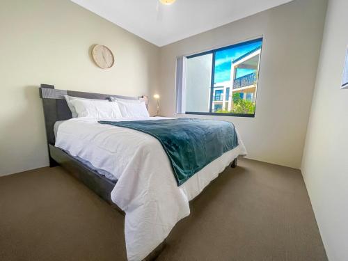 a bedroom with a large bed and a window at Ground Garden-Two King Beds&One Queen Bed in Perth