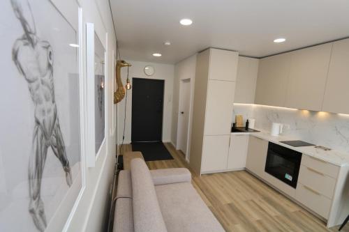 a kitchen with a staircase leading to a living room at Flat for 2 or 1 with Free Parking and Fast Wi-Fi in Vilnius