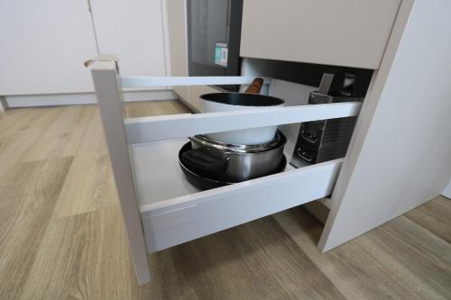 a white shelf with a pot on it in a kitchen at Flat for 2 or 1 with Free Parking and Fast Wi-Fi in Vilnius