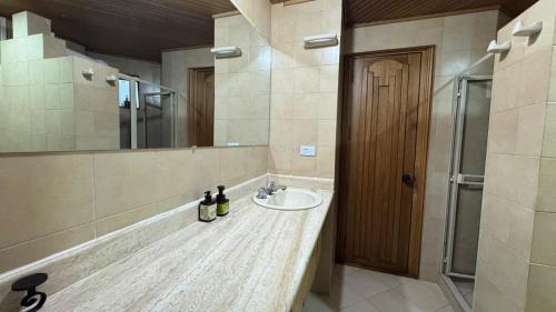 a bathroom with a sink and a mirror at Casa ROMERO EN FLOR in Medellín