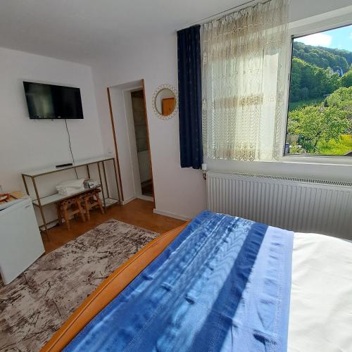 a bedroom with a bed and a large window at Pensiunea Mateo in Bran