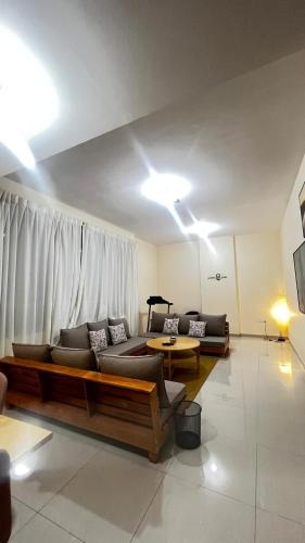 a living room with two couches and a table at Rest House Hostel in Abu Dhabi