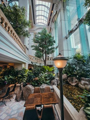 a lobby with a table and chairs in a building at Grand Hyatt Erawan Bangkok in Bangkok