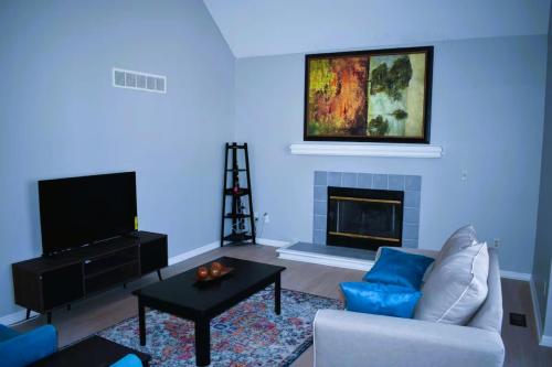 a living room with a couch and a fireplace at Cozy 3BR-3BA Home Near Zona Rosa Shopping and Dining in Kansas City