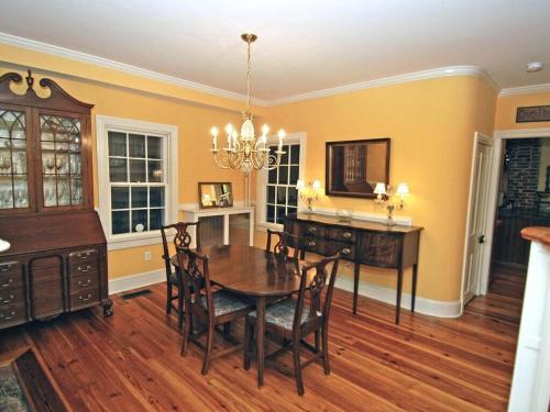 a dining room with a table and a desk at 1879 Downtown Annapolis Home with Koi Ponds and Gardens in Annapolis