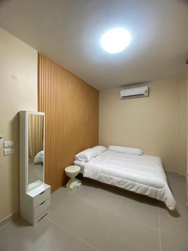 a bedroom with a bed and a sink and a mirror at FUJI Hotel in Nakhon Ratchasima