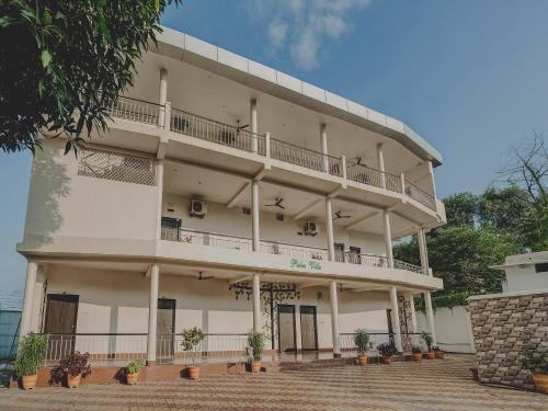 a large white building with a balcony at Super Capital O Gulmohar Marriage Garden in Dhanbād