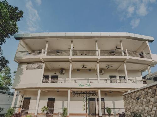 a building with a balcony on top of it at Super Capital O Gulmohar Marriage Garden in Dhanbād