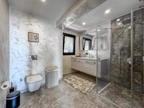 a bathroom with a shower and a toilet and a sink at Villa Onya in Bodrum City