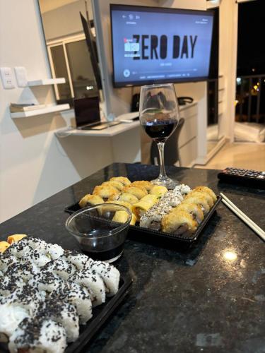 a table with a bunch of donuts and a glass of wine at Monoambiente p3 personsas a pasos de Av Sta Teresa Asuncion, con balcon y Gran vista in Fernando de la Mora