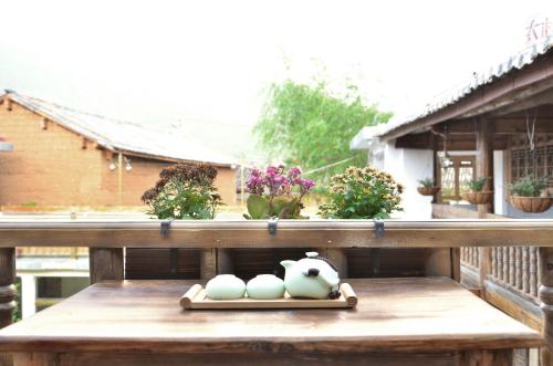 a tray of eggs sitting on a table on a balcony at Tourist Courtyard Hotel in Jianchuan