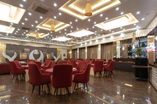 a dining room with a long table and red chairs at Hotel Shashi Grand, Jamui in Jamūi