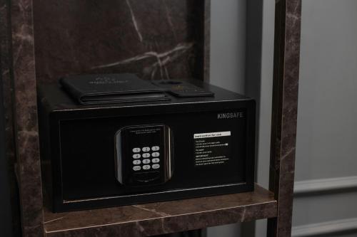 a black microwave oven sitting on a shelf at Madelise Hanoi View Hotel in Hanoi