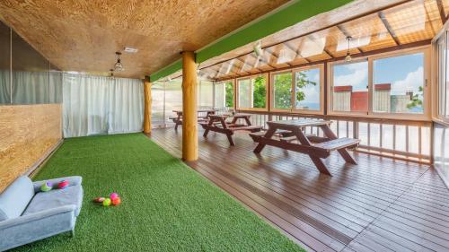 a living room with a couch and a table and chairs at Goseong Sea&Star pension in Goseong