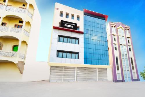 a building with a garage door in front of it at Super Townhouse OAK Santosh Nagar Hyderabad in Hyderabad