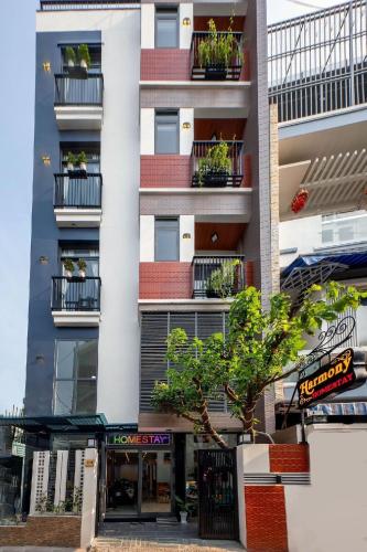 an apartment building with potted plants on the balconies at Harmony Homestay in Da Nang