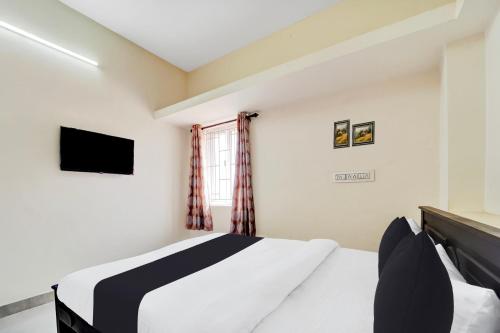 Postel nebo postele na pokoji v ubytování Super Hotel O Viswapuram