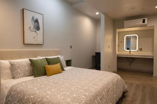a bedroom with a large bed and a mirror at Oaktown Roost in Oakland