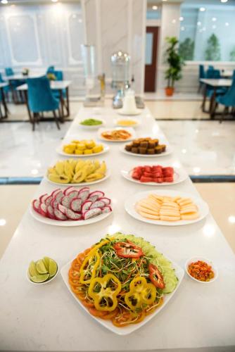 a table with many plates of food on it at Urbanite Hotel in Vientiane