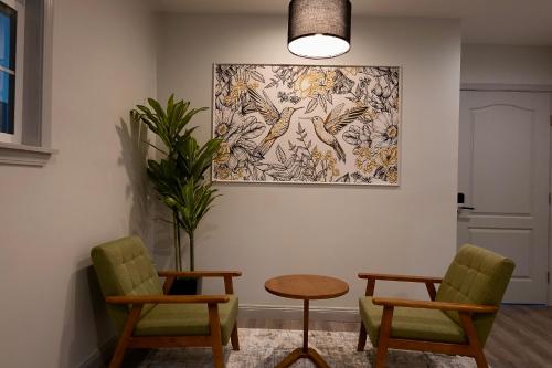 a room with two chairs and a table and a painting at Oaktown Roost in Oakland