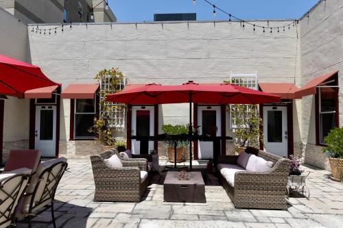a patio with chairs and umbrellas and a table at Oaktown Roost in Oakland