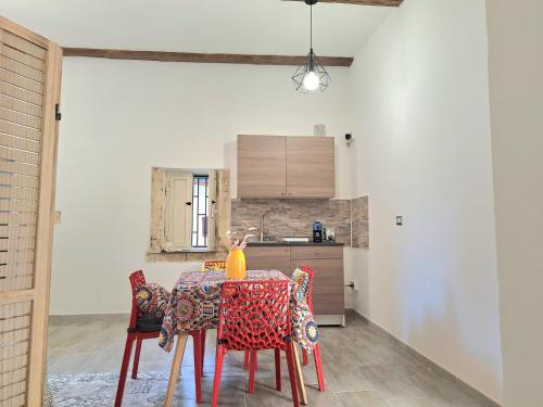 a dining room with a table and chairs at Nata Sicula 3 in Siracusa