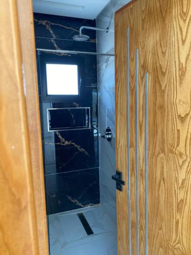 a shower with a glass door in a bathroom at La Villa Margautin in Arkou