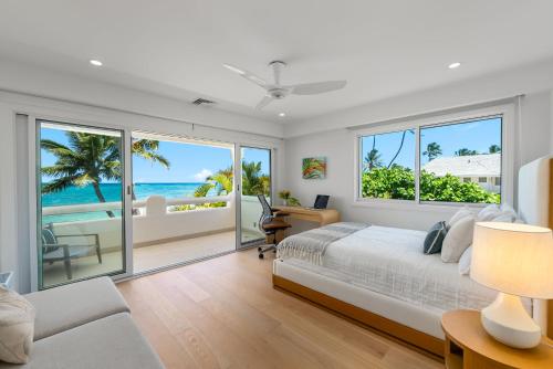 a bedroom with a bed and views of the ocean at Lanikai Sunrise in Kailua