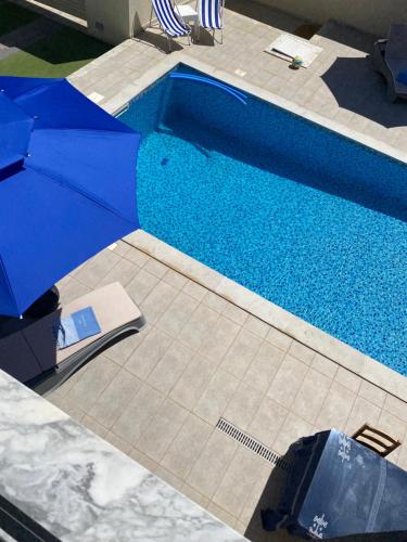 an overhead view of a swimming pool with an umbrella at La Villa Margautin in Arkou